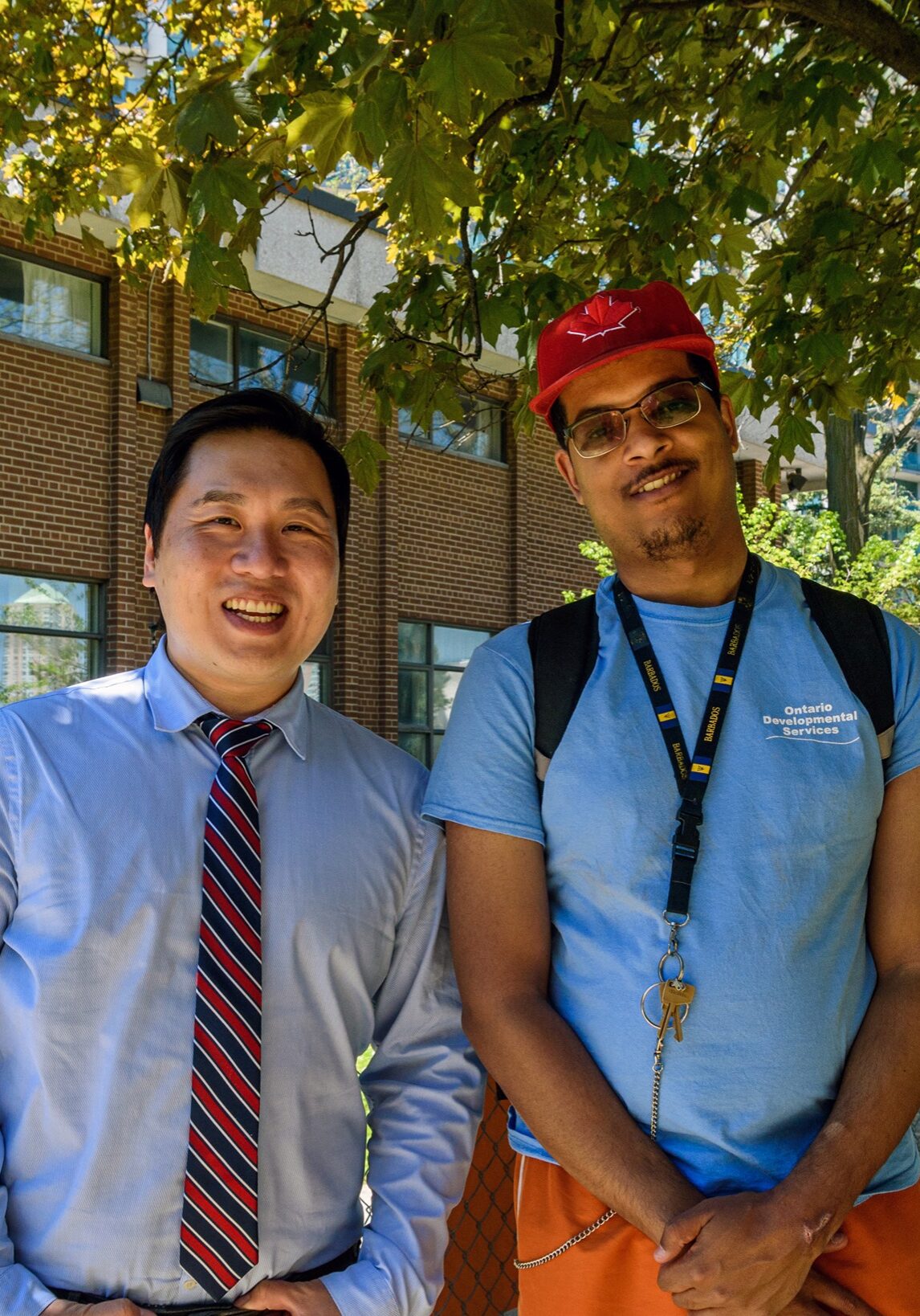 2 men posing outside with smiles